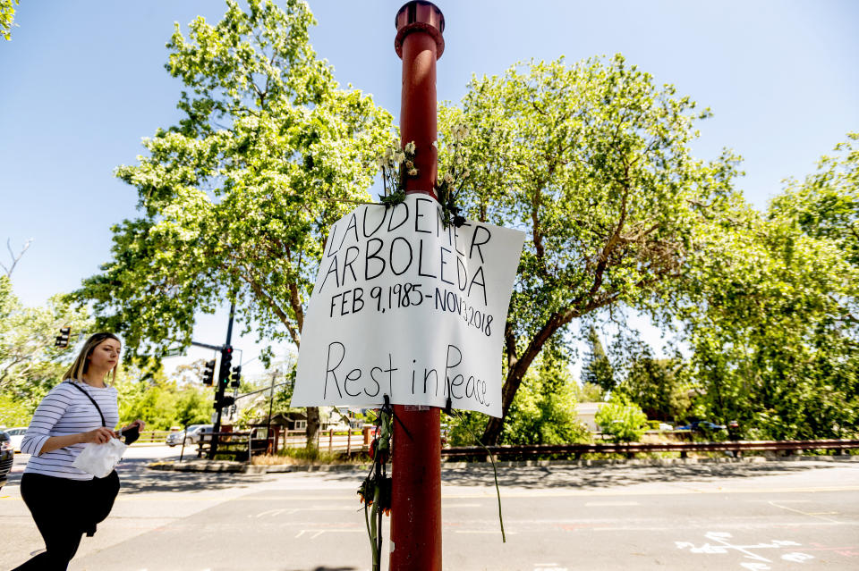 A memorial sign marks the Danville, Calif., location Monday, May 3, 2021, where Danville police officer Andrew Hall shot and killed Laudemer Arboleda during a 2018 car chase. Hall faces felony charges stemming from the shooting. This and another fatal shooting by the same police officer in a wealthy San Francisco suburb have cast a spotlight on what criminal justice activists are calling a case of delayed justice and its deadly consequences. (AP Photo/Noah Berger)