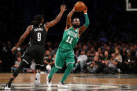Nov 14, 2017; Brooklyn, NY, USA; Boston Celtics point guard Kyrie Irving (11) passes the ball away from Brooklyn Nets small forward DeMarre Carroll (9) during the fourth quarter at Barclays Center. Mandatory Credit: Brad Penner-USA TODAY Sports