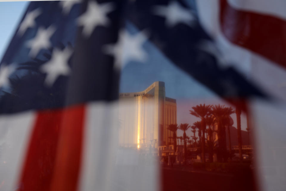 The Mandalay Bay hotel is shown through an American flag blowing in the wind at a memorial next to the mass shooting site along the Las Vegas Strip in Las Vegas, Nevada, U.S., October 4, 2017. (Photo: Mike Blake / Reuters)