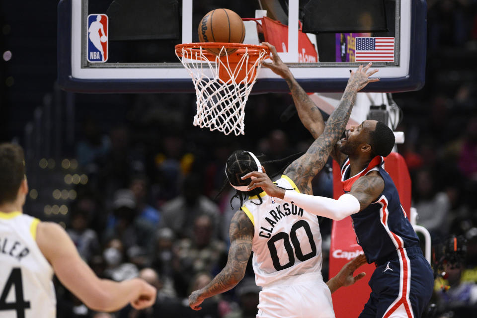 Washington Wizards forward Will Barton, right, dunks against Utah Jazz guard Jordan Clarkson during the first half of an NBA basketball game Saturday, Nov. 12, 2022, in Washington. (AP Photo/Nick Wass)