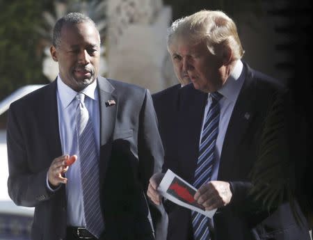 Republican U.S. presidential candidate Donald Trump (R) speaks with former Republican presidential candidate Ben Carson (L) after receiving after receiving Carson's endorsement at a campaign event in Palm Beach, Florida March 11, 2016. REUTERS/Carlo Allegri