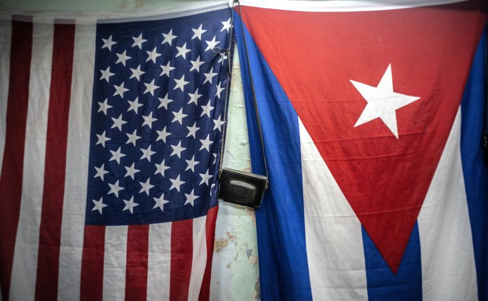 <span class="caption">American and Cuban flags hang from a wall with an old camera hung in between in Havana, Cuba, on Jan. 11, 2021.</span> <span class="attribution"><span class="source">(AP Photo/Ramon Espinosa)</span></span>