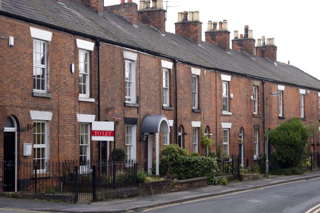 'Row of terraced houses in Alderley Edge, Cheshire, UK. The nearest house is available to rent.'