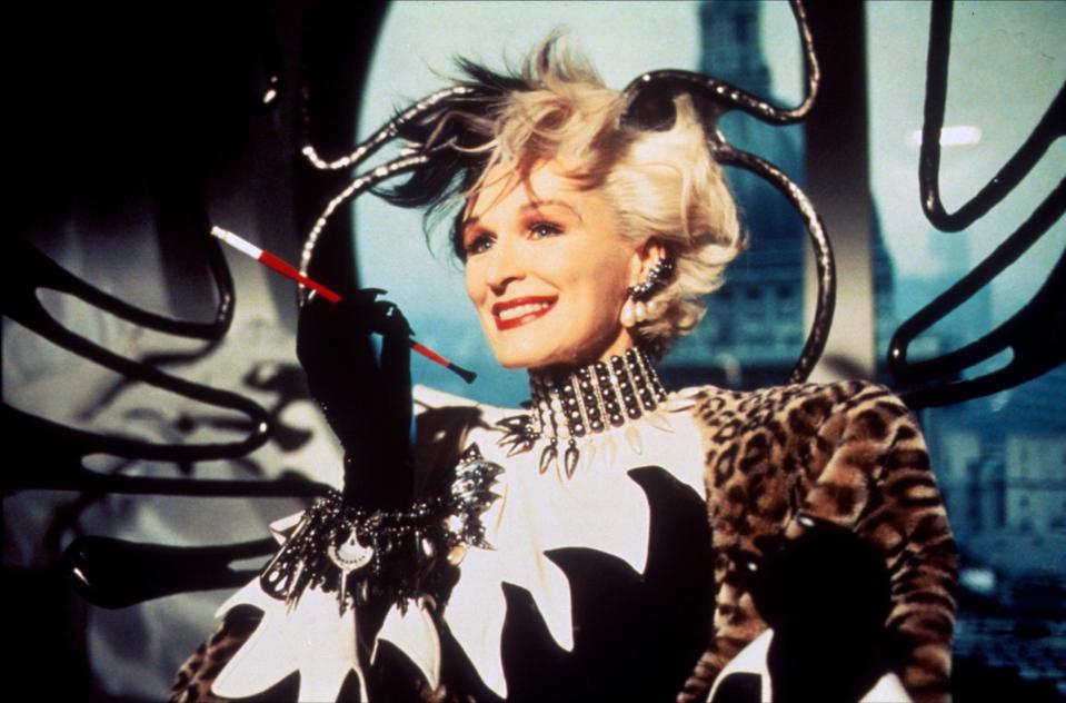 Glenn Close as Cruella de Vil in 101 Dalmatians, holding a cigarette and smiling