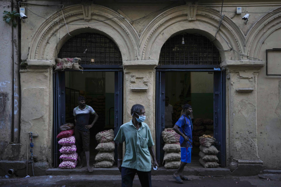 Merchants of imported food items wait to trade them at a wholesale market in Colombo, Sri Lanka, Sunday, June 26, 2022. Sri Lankans have endured months of shortages of food, fuel and other necessities due to the country's dwindling foreign exchange reserves and mounting debt, worsened by the pandemic and other longer term troubles. (AP Photo/Eranga Jayawardena)