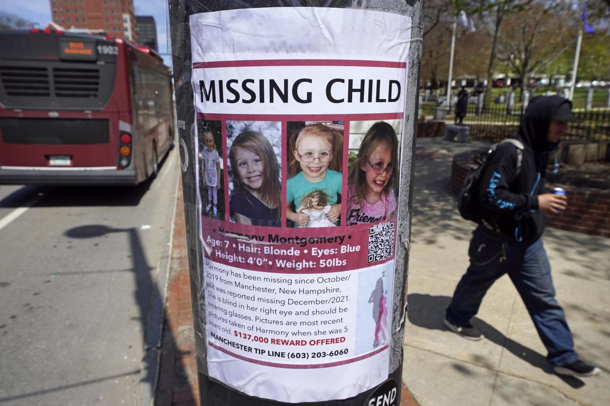 A man walks past a "missing child" poster for Harmony Montgomery back in May. The girl is now presumed to be dead.