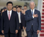 FILE - In this Sept. 24, 2015, file photo, Chinese President Xi Jinping, Vice President Joe Biden, stand for the U.S. national anthem during an arrival ceremony in Andrews Air Force Base, Md. (AP Photo/Carolyn Kaster, File)