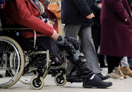 A man in a wheelchair attends a ceremony at the Maelbeek metro station to commemorate two years since bombings at Brussels airport and a metro station, in Brussels, Belgium March 22, 2018. Olivier Hoslet/Pool via REUTERS