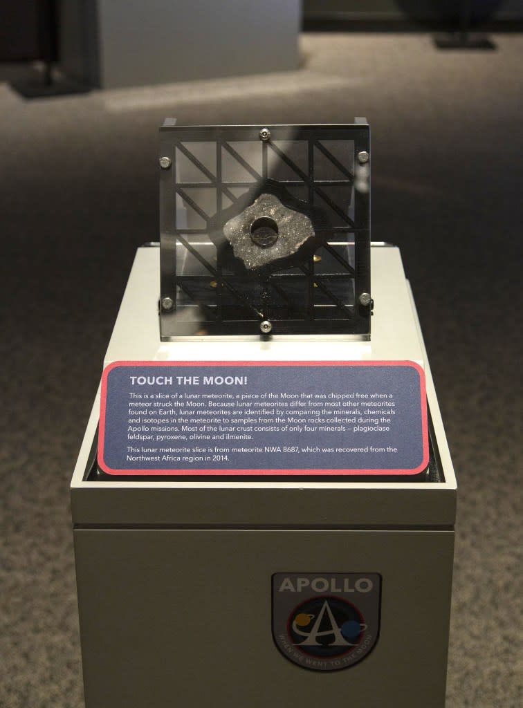 The new Apollo spaceflight program exhibit at the Intrepid Museum, which opened Tuesday, lets visitors touch a lunar meteorite. Intrepid Museum