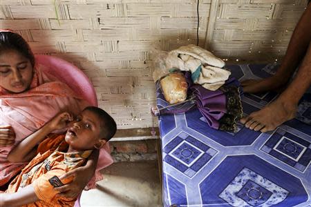 A sick Rohingya boy waits to receive medical treatment at a makeshift clinic at the Thet Kae Pyin camp for internally displaced people in Sittwe, Rakhine state, April 24, 2014. REUTERS/Minzayar (