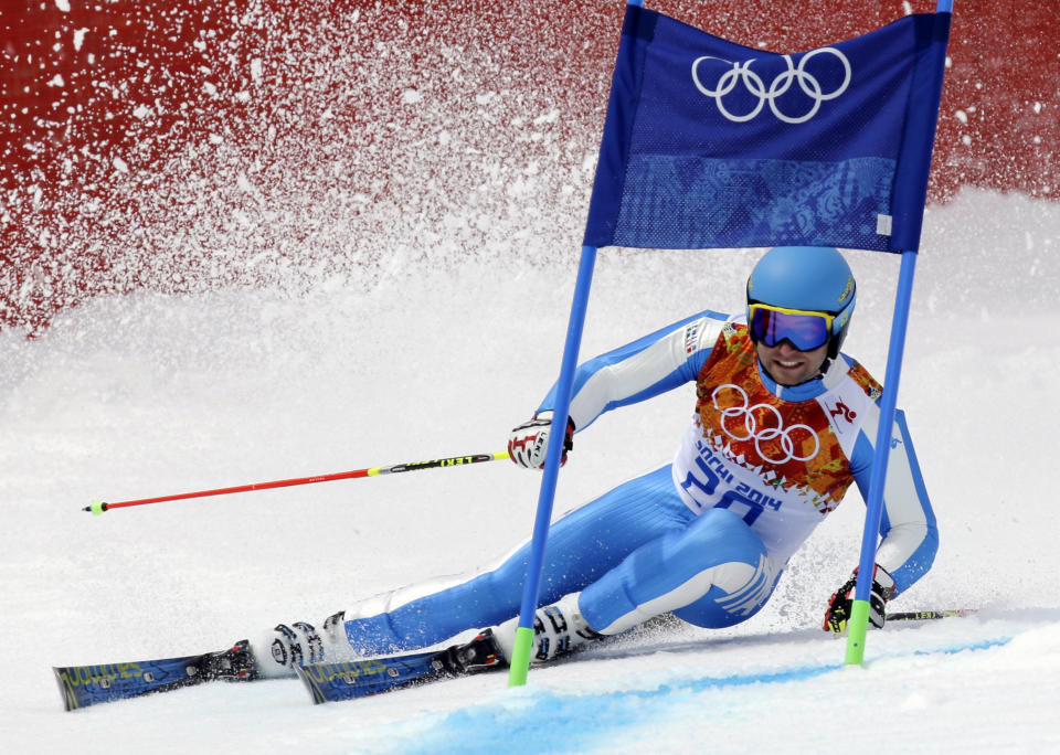 Italy's Davide Simoncelli approaches a gate in the first run of the men's giant slalom at the Sochi 2014 Winter Olympics, Wednesday, Feb. 19, 2014, in Krasnaya Polyana, Russia.