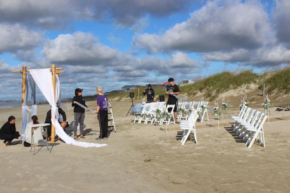 The "I Do Crew" sets up for a wedding on Oak Island on Saturday, October 1 where Hurricane Ian's storm surge had been crashing onto the beach less than 24 hours before.