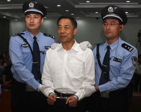 Ousted Chinese politician Bo Xilai (C) is handcuffed after the announcement of his verdict inside the court in Jinan, Shandong province September 22, 2013, in this photo released by Jinan Intermediate People's Court. REUTERS/Jinan Intermediate People's Court/Handout via Reuters
