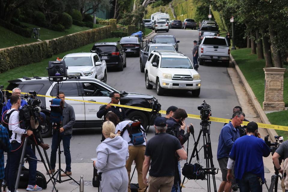 Police and members of the media gather outside Sean "Diddy" Combs' home in Los Angeles on March 25, 2024.