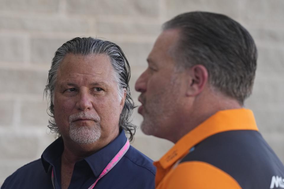 Michael Andretti, left, listens as McLaren CEO Zak Brown speaks in the paddock ahead of the Formula One U.S. Grand Prix auto race at Circuit of the Americas, Friday, Oct. 20, 2023, in Austin, Texas. (AP Photo/Darron Cummings)