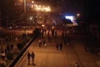 People walk to the city as coca farmers and supporters of Bolivia's ousted President Evo Morales stage a blockade of an entrance to Sacaba