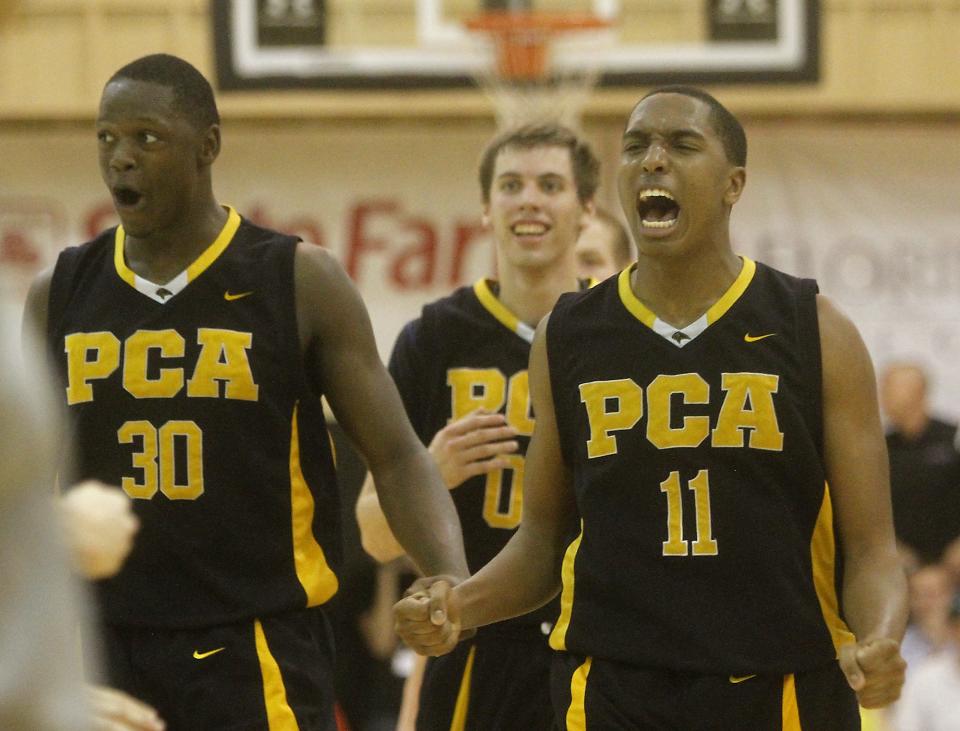 Prestonwood Christian teammates, from left, Julius Randle, Mickey Mitchell, and Austin Rettig, celebrate on the way to beating Arlington Grace in the championship game of the City of Palms Classic at Bishop Verot High School on Dec. 21, 2011.