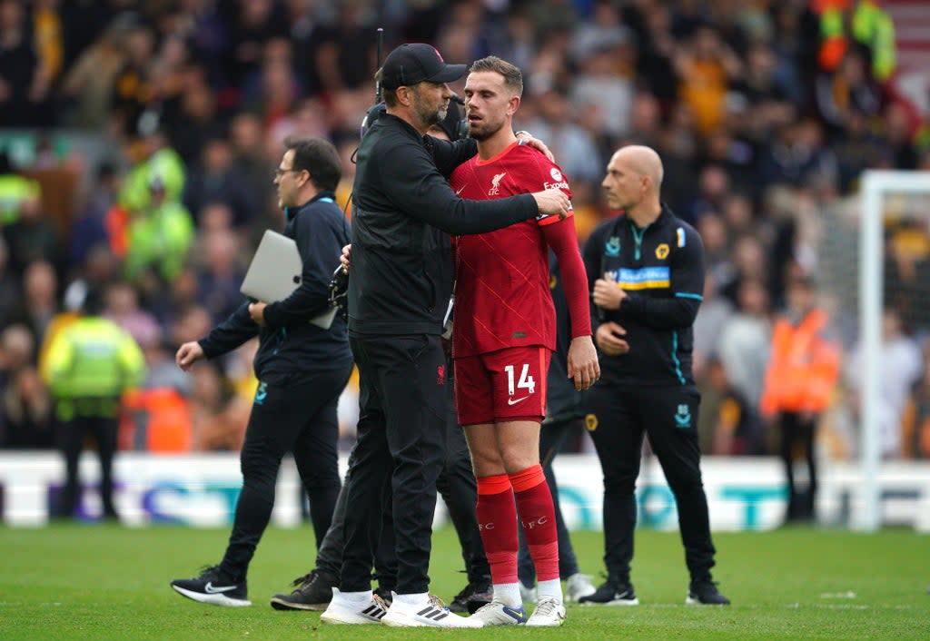 Liverpool manager Jurgen Klopp embraces captain Jordan Henderson after the final whistle (Peter Byrne/PA) (PA Wire)