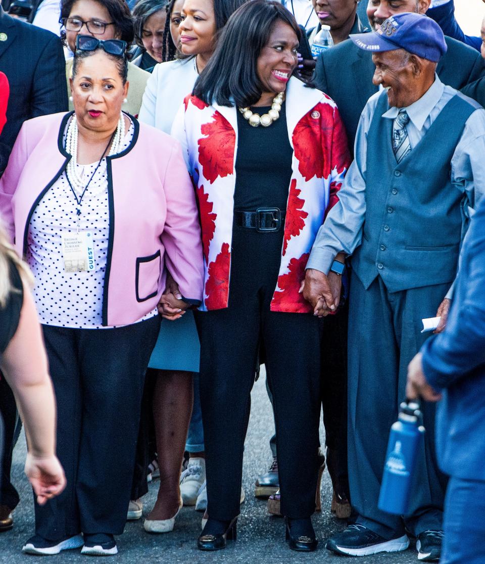 Rep. Terri Sewell, center , stands between foot soldiers Sheyann Webb - Christburg and George Sallis as President Joe Biden visits the Edmund Pettus Bridge in Selma, Ala., on Sunday March 5, 2023 to commemorate the 58th anniversary of the Bloody Sunday bridge crossing.