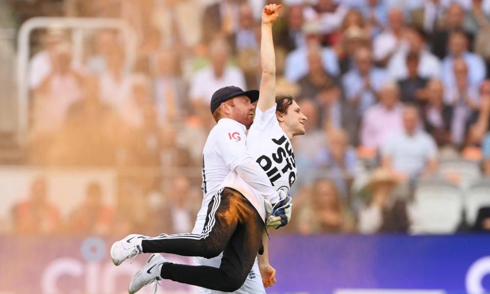 Jonny Bairstow removes a pitch invader during day one of the second Ashes Test.