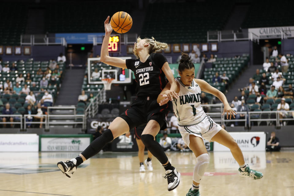 Stanford forward Cameron Brink (22) crashes into Hawaii guard Kelsie Imai (1) as they go for a loose ball during the third quarter of an NCAA college basketball game, Sunday, Nov. 27, 2022, in Honolulu. (AP Photo/Marco Garcia)