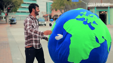 person hugging someone dressed as the earth