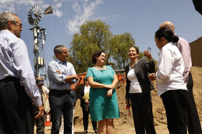 Irvine, California-Aug. 18, 2022-At the Rattlesnake Recycled Water Pump Station, Secretary of the Interior Deb Haaland, third from right, speaks to the other leaders regarding the Bipartisan Infrastructure Law which allocates a total of $8.3 billion for Reclamation infrastructure projects to repair aging water delivery systems. From left is Wade Crowfoot, Secretary of Natural Resources, State of California, second from left; Congresswoman Katie Porter (CA-45), third from left, Secretary of the Interior Deb Haaland, fourth from left, Bureau of Reclamation Commissioner Camille Calimlim Touton, far right; and Paul Cook, general manager of the Irvine Ranch Water District, behind Calimlim Touton.(Carolyn Cole / Los Angeles Times)