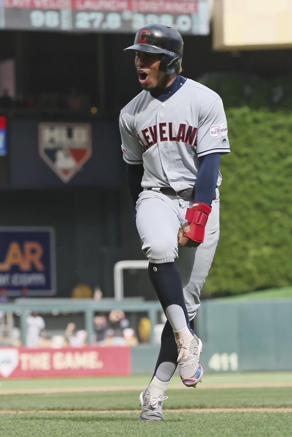 Cleveland Indians Greg Allen celebrates as he rounds the bases on a grand slam by Carlos Santana off Minnesota Twins pitcher Taylor Rogers in the 10th inning of a baseball game Sunday, Aug. 11, 2019, in Minneapolis. The Indians won 7-3. Allen homered in the first inning. (AP Photo/Jim Mone)