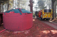 Dried fire retardant from an aerial tanker clings to a water tank during the Soberanes Fire in the mountains above Carmel Highlands, California, U.S. July 28, 2016. REUTERS/Michael Fiala