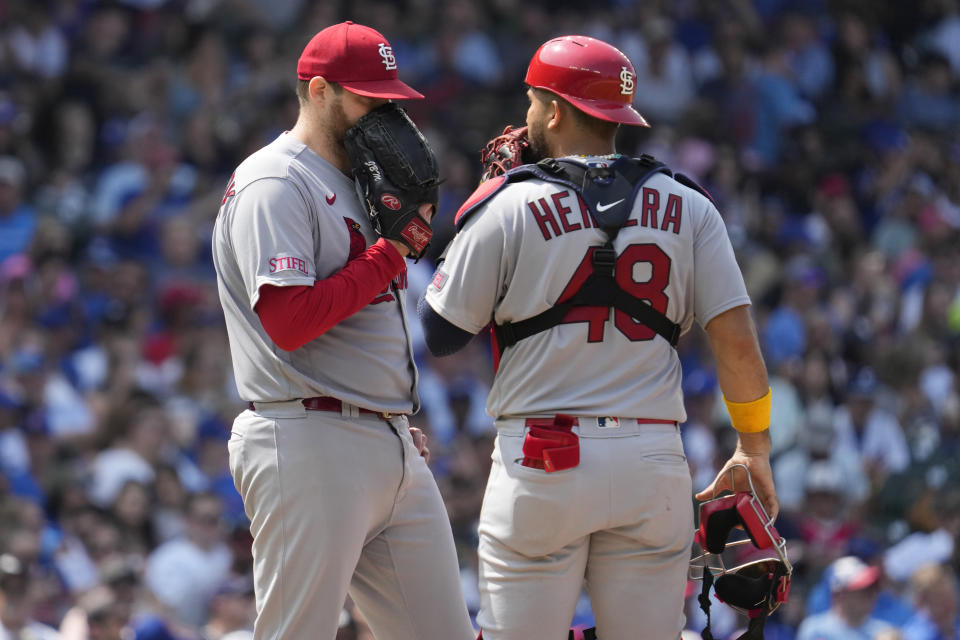 St. Louis Cardinals starting pitcher Jordan Montgomery, left, talks with catcher Ivan Herrera during the sixth inning of a baseball game against the Chicago Cubs in Chicago, Sunday, July 23, 2023. (AP Photo/Nam Y. Huh)