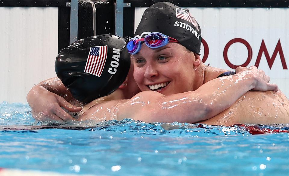 Team USA's Morgan Stickney (R) is congratulated by Coan McKenzie after her victory during the women's S7 400m freestyle final event at the Paris Paralympic Games.