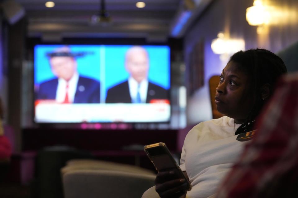 Blair Savage, 37, watches the Presidential Debate at a watch party at the M Lounge in the South Loop neighborhood of Chicago, Thursday, June 27, 2024. Savage, who identifies as a Democrat, says reproductive rights are the key issues this election season for her. (AP Photo/Charles Rex Arbogast)