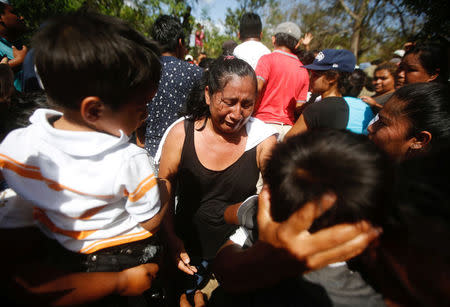 A relative cries next to Jairo Hernandez's casket during his funeral at the cemetery in Masaya, who according to the nation's Red Cross was shot dead during a protest over a controversial reform to the pension plans of the Nicaraguan Social Security Institute (INSS) in Nicaragua April 21, 2018. REUTERS/Jorge Cabrera