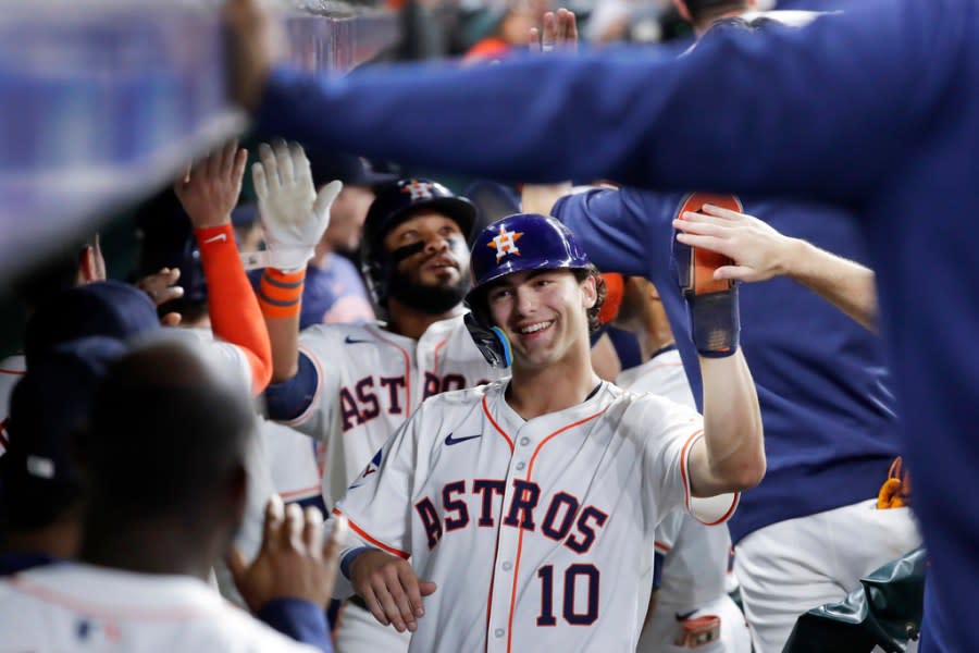 Houston Astros’ <a class="link " href="https://sports.yahoo.com/mlb/players/9099/" data-i13n="sec:content-canvas;subsec:anchor_text;elm:context_link" data-ylk="slk:Jon Singleton;sec:content-canvas;subsec:anchor_text;elm:context_link;itc:0">Jon Singleton</a>, left, and Joey Loperfido (10) collect high fives in the dugout after they both scored on the three run home run by Singleton against the Cleveland Guardians during the fourth inning of a baseball game Tuesday, April 30, 2024, in Houston. Loperfido batted in two run on his RBI single for his first major league hit just before Singleton’s home run.(AP Photo/Michael Wyke)