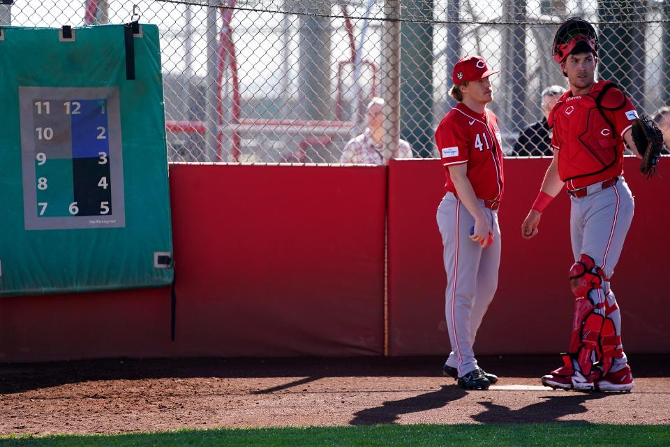 Cincinnati Reds pitcher Andrew Abbott (41) and Cincinnati Reds catcher Tyler Stephenson (37) talk in the bullpen during spring training workouts, Friday, Feb. 16, 2024, at the team’s spring training facility in Goodyear, Ariz.