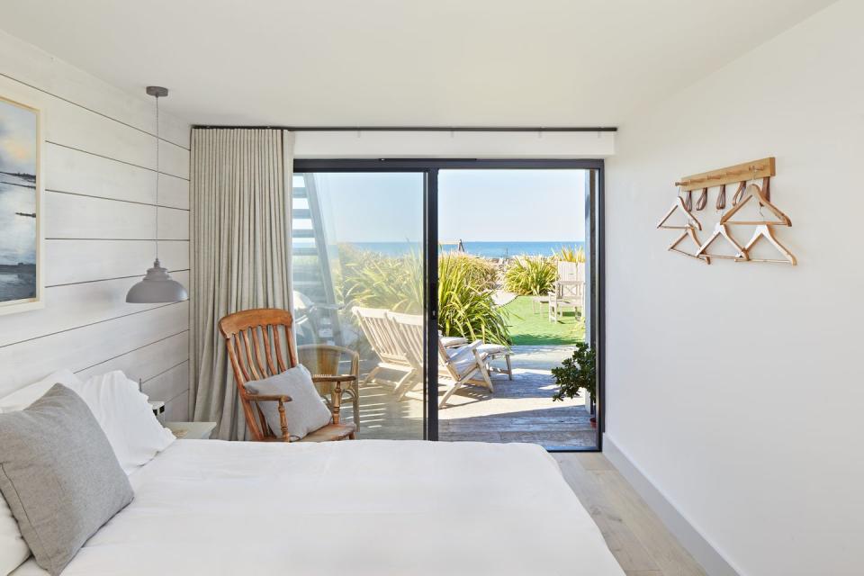 coastal bedroom with timber clad walls overlooking the sea