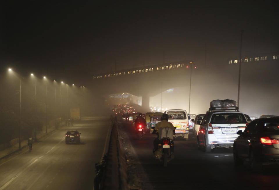 FILE - Commuters drive on a road engulfed in smog in New Delhi, India, Thursday, Nov. 5, 2020. The U.N. health agency said Monday, April 4, 2022, nearly everybody in the world breathes air that doesn’t meet its standards for air quality, calling for more action to reduce fossil-fuel use, which generates pollutants that cause respiratory and blood-flow problems and lead to millions of preventable deaths each year. (AP Photo/Manish Swarup, File)