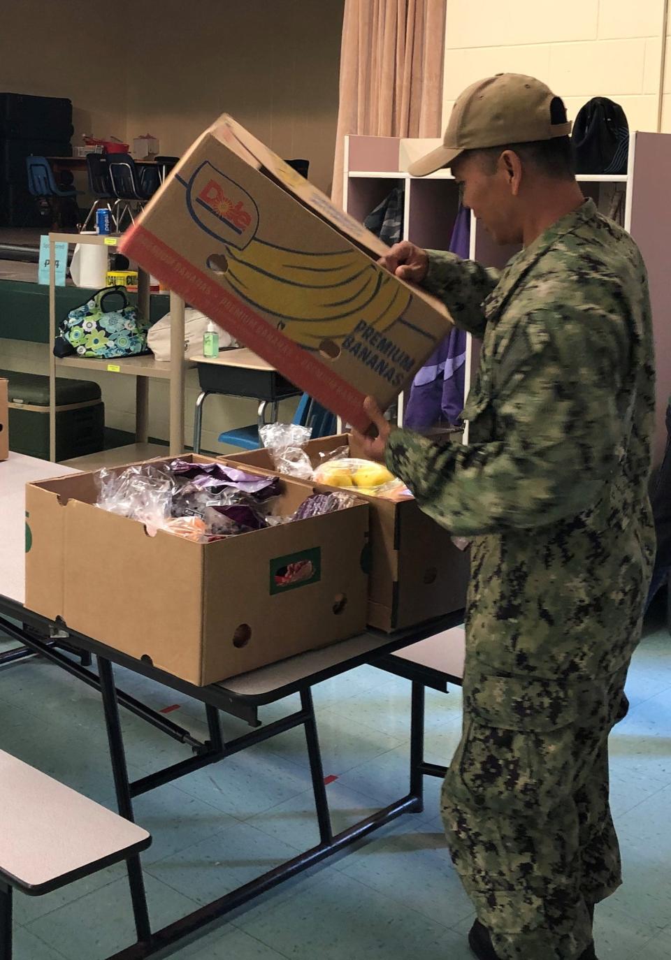 A volunteer unloads fresh groceries for the BEAM food pantry. The agency recently partnered with the Mayport USO to help fight food insecurity among military families.