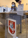 A man casts his ballot at a polling station during early voting in the second round of a parliamentary election in Vilnius, Lithuania, Thursday, Oct. 22, 2020. Lithuanians will vote in the second round of a parliamentary election on upcoming Sunday during the rise in the incidence of coronavirus infection in the country. (AP Photo / Mindaugas Kulbis)