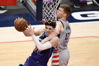 Charlotte Hornets guard LaMelo Ball, left, is fouled by Washington Wizards forward Davis Bertans (42) during the second half of an NBA basketball game, Sunday, May 16, 2021, in Washington. The foul was upgraded to a flagrant one. (AP Photo/Nick Wass)