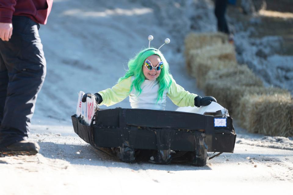 Brooklyn Croskey races her sled during the Festivus Cardboard Sled Race at Leila Arboretum on Saturday, Feb. 11, 2023.