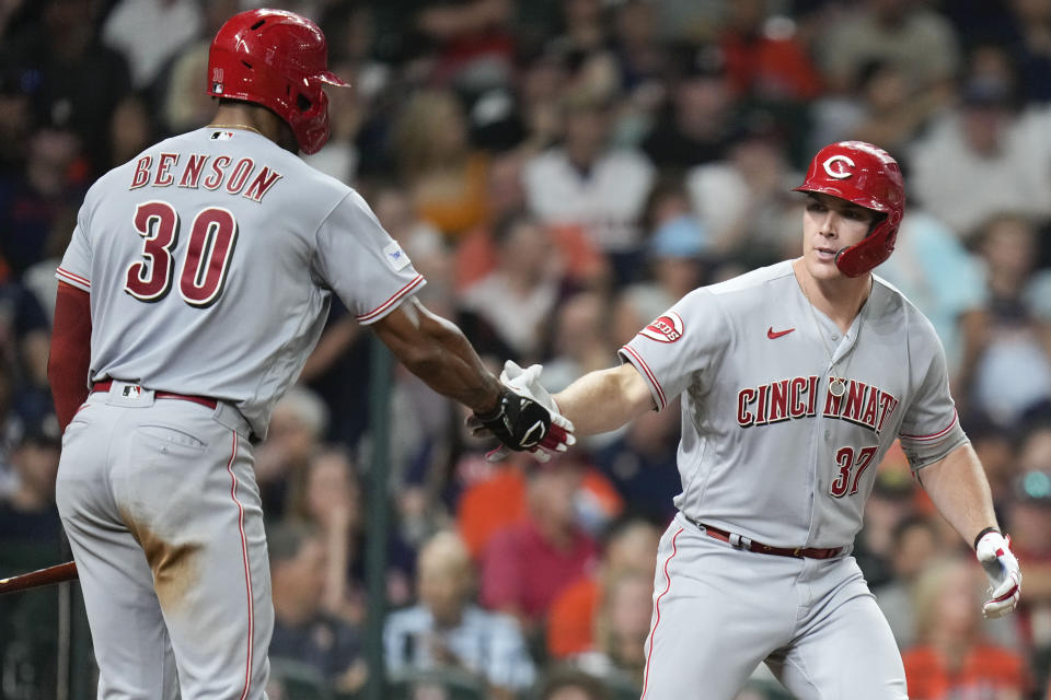 Cincinnati Reds designated hitter Tyler Stephenson, right, celebrates after his solo home run with Will Benson during the seventh inning of a baseball game against the Houston Astros, Friday, June 16, 2023, in Houston. (AP Photo/Eric Christian Smith)