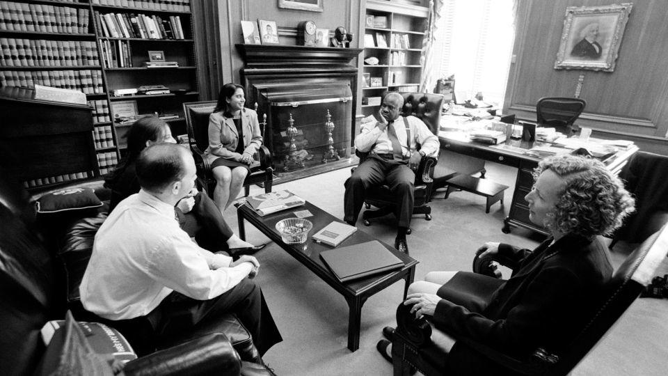 Supreme Court Justice Clarence Thomas meets with his law clerks during the 2001-2002 term. - David Hume Kennerly/Getty Images