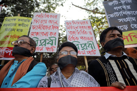 Activists of leftist alliance cover their mouth with black cloths as they join in a rally to demand a new election under caretaker government, in Dhaka, Bangladesh, January 3, 2019. REUTERS/Mohammad Ponir Hossain
