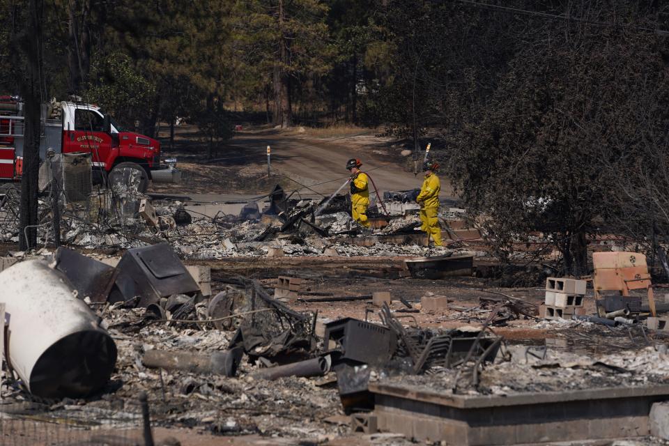 Firefighters spray water on the rubble of what was a home near downtown Weed on Saturday, Sept. 3, 2022. It was the day after the Mill Fire broke out in Weed and raced north toward the Northern California community of Lake Shastina near the Oregon border. Cal Fire crews were mopping up hot spots in Weed and Lake Shastina.