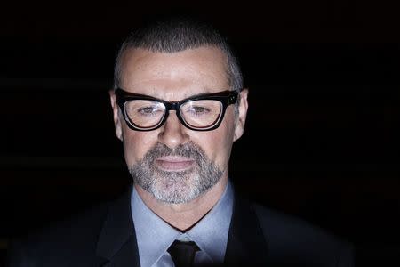 FILE PHOTO - British singer George Michael poses for photographers before a news conference at the Royal Opera House in central London May 11, 2011. REUTERS/Stefan Wermuth/File Photo