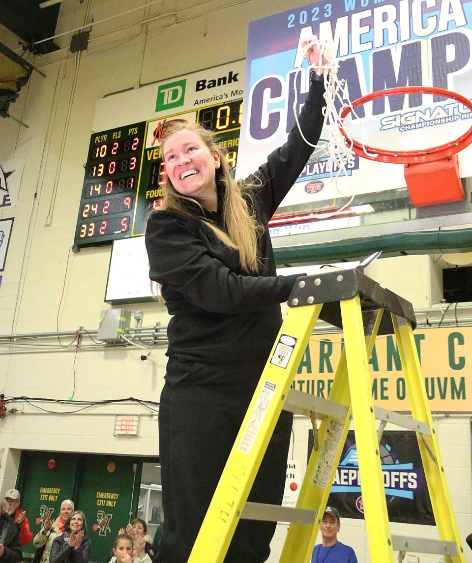 Vermont coach Alisa Kresge cuts down the net after the Catamounts 38-36 win over Albany in the America East championship game on Friday night at Patrick Gym.