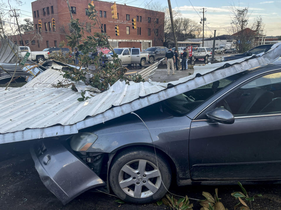A damaged vehicle and debris are seen in the aftermath of severe weather, Thursday, Jan. 12, 2023, in Selma, Ala. A large tornado damaged homes and uprooted trees in Alabama on Thursday as a powerful storm system pushed through the South. (AP Photo/Butch Dill)