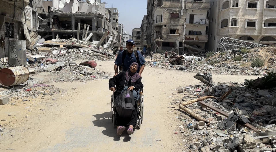 A worker from the Kamal al-Adwan hospital evacuates a Palestinian patient after Israeli airstrikes damaged the hospital in the Jabalia refugee camp in the northern Gaza Strip, May 21, 2024. / Credit: Karam Hassan/Anadolu/Getty