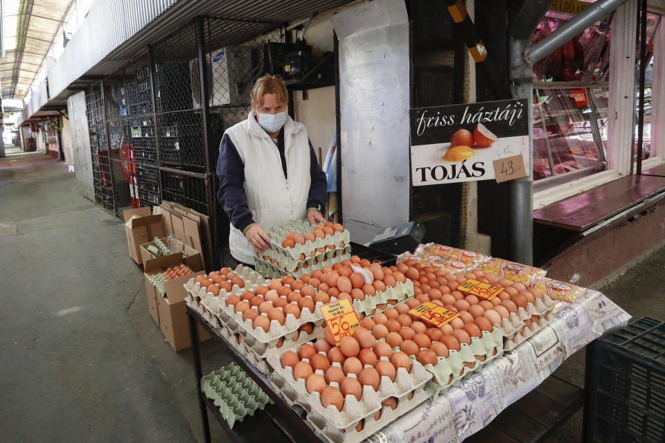 An egg vendor waits for customers at a deserted market in Budapest, Hungary, Thursday, March 25, 2021. Hungary, with the world's highest per capita death rate, set a record for daily deaths on Thursday with 252, bringing the death toll to nearly 19,000 in the country, which has a population of less than 10 million. (AP Photo/Laszlo Balogh)